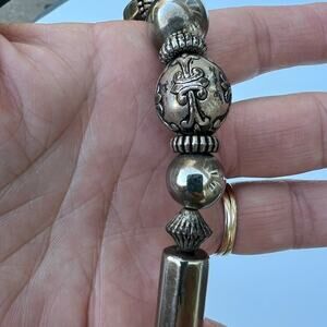 Tarnished silver color beaded necklace. Multiple shapes & sizes of silver color